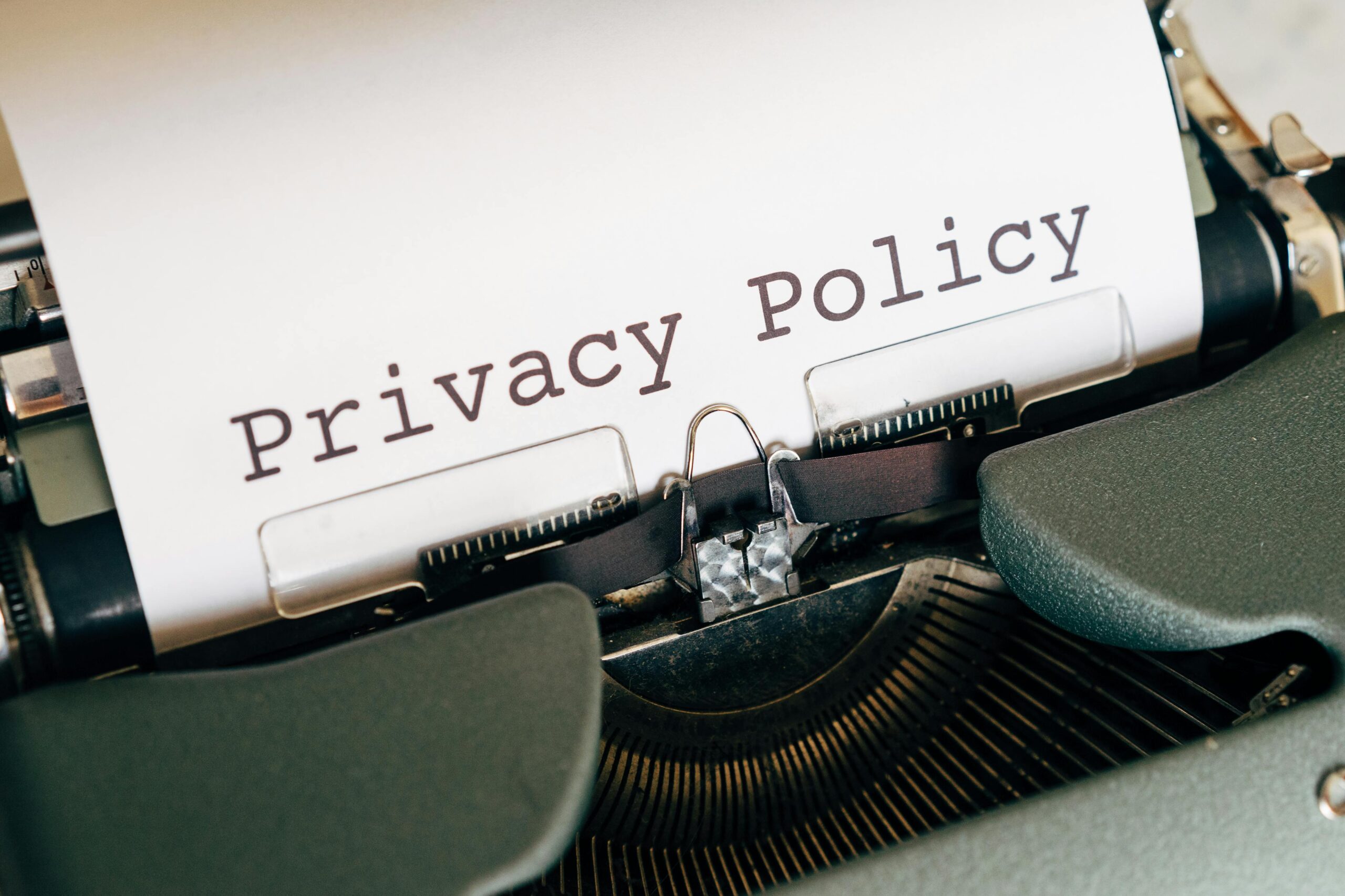 pexels-photo-4152513-4152513 A vintage typewriter writing 'Privacy Policy' on paper, capturing an old-school conceptual theme.